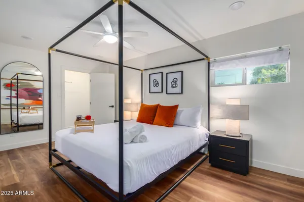 a bedroom with a bed and wooden floor