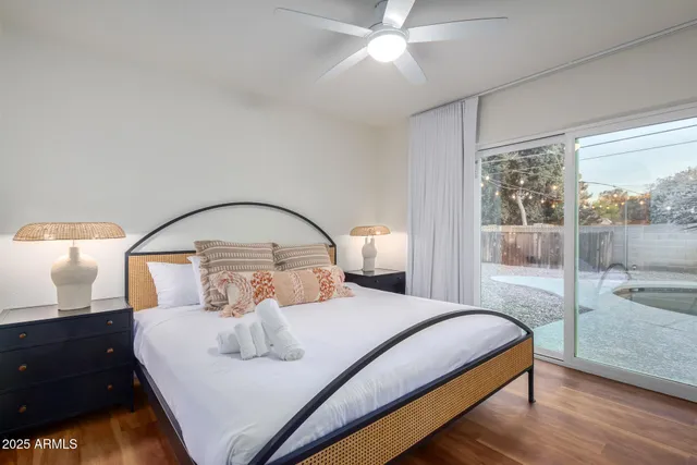 a bedroom with a bed and a large window