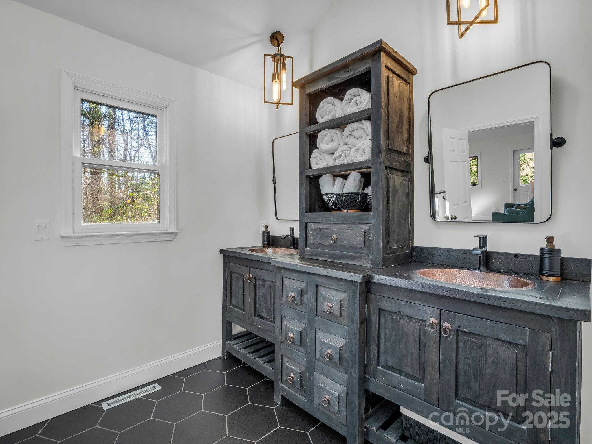 158 Rock Spring Road Lake Lure, NC 28746 - Photo 21 of 48 a bathroom with a sink and a mirror