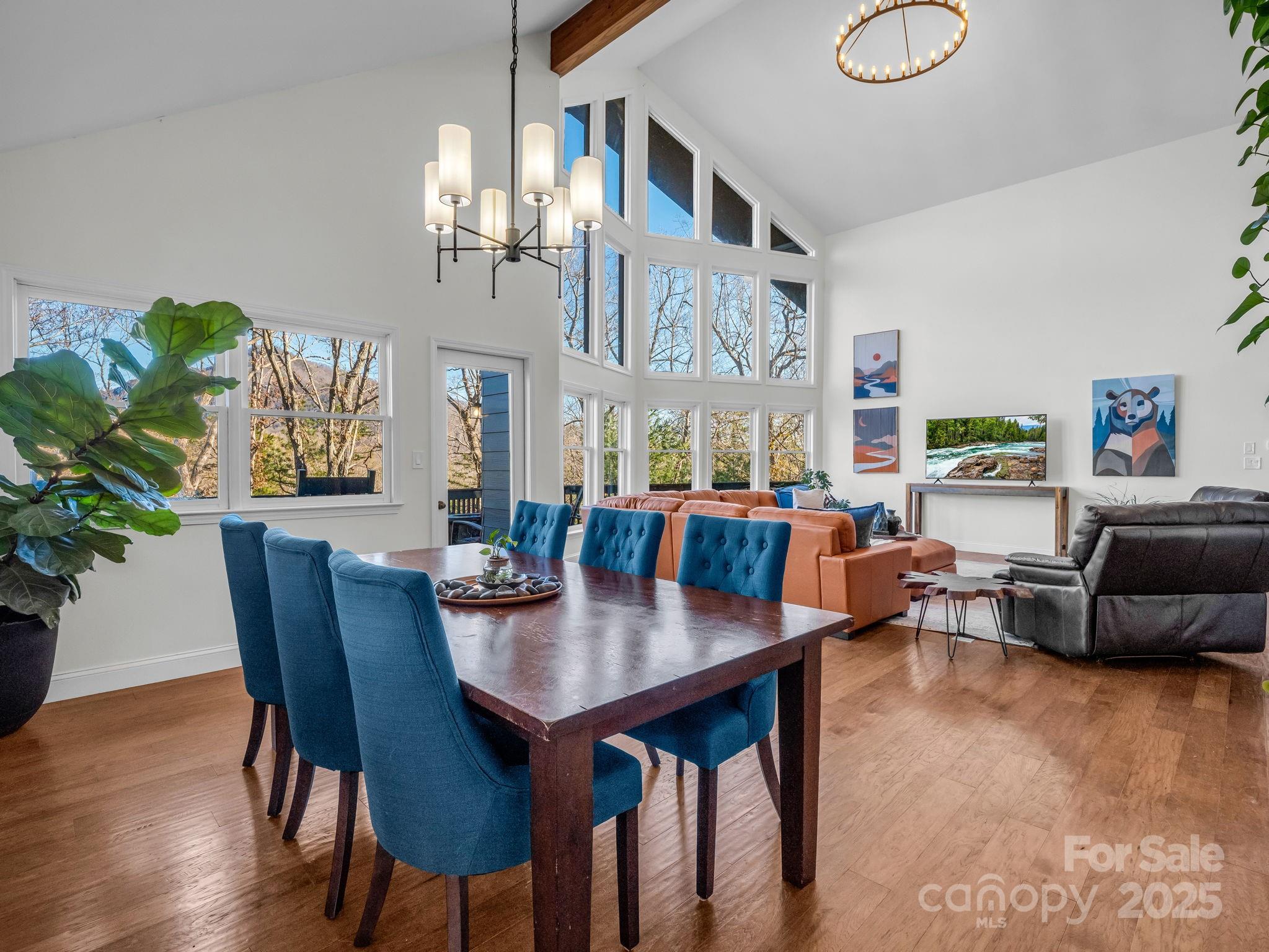 158 Rock Spring Road Lake Lure, NC 28746 - Photo 6 of 48 a living room with furniture a chandelier and a dining table