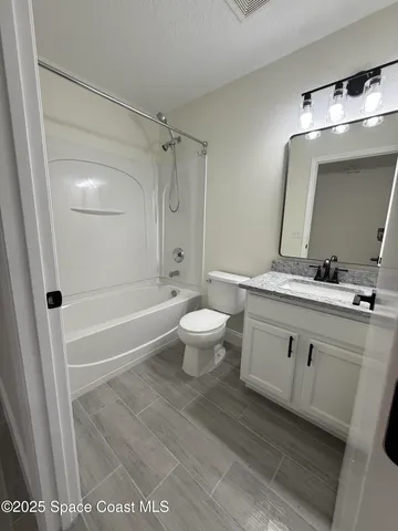 a bathroom with a double vanity sink toilet mirror and shower