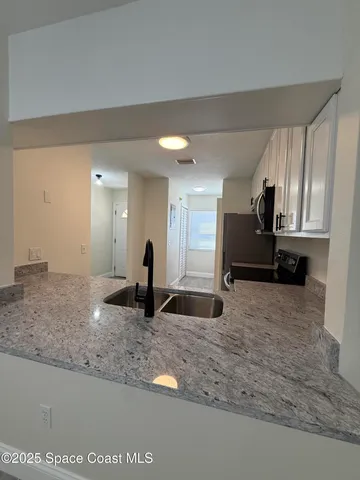 a view of a kitchen with a sink