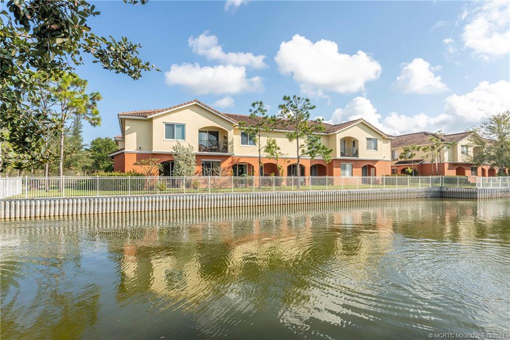 55 Southeast Palermo, Unit 102 Stuart, FL 34994 - Photo 1 of 40 a front view of a house with a lake view