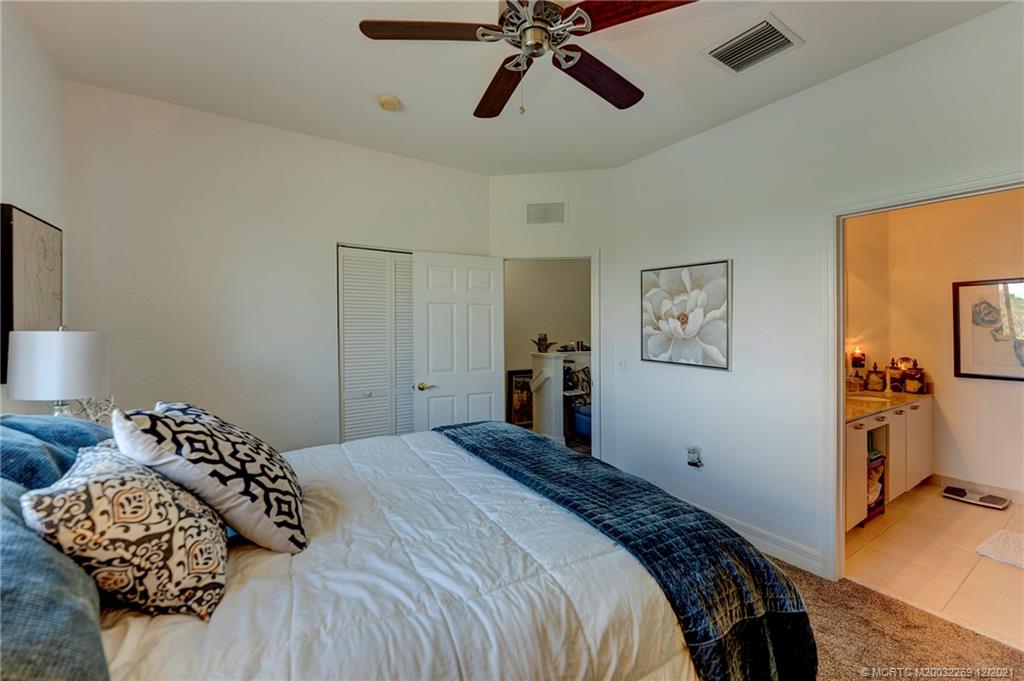 55 Southeast Palermo, Unit 102 Stuart, FL 34994 - Photo 12 of 40 a bedroom with a bed and wooden floor