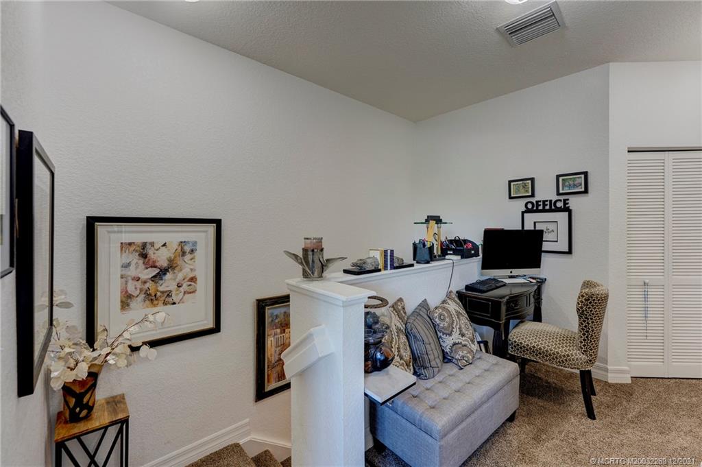55 Southeast Palermo, Unit 102 Stuart, FL 34994 - Photo 13 of 40 a living room with furniture and a painting on the wall