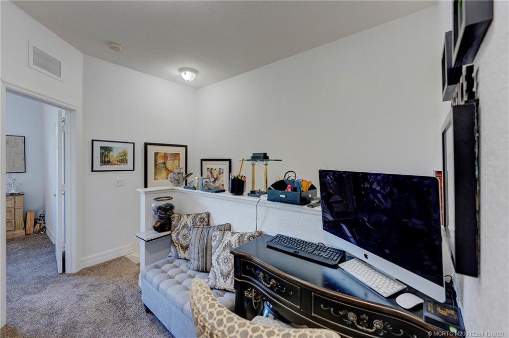 55 Southeast Palermo, Unit 102 Stuart, FL 34994 - Photo 14 of 40 a living room with furniture and a piano