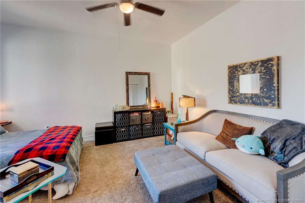 55 Southeast Palermo, Unit 102 Stuart, FL 34994 - Photo 16 of 40 a living room with furniture and a lamp