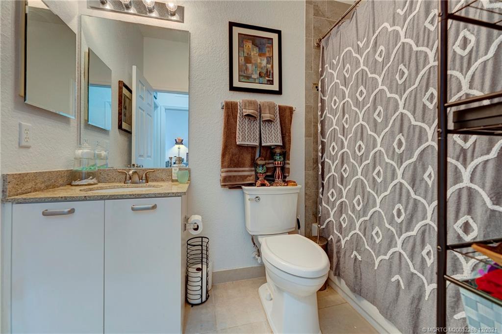 55 Southeast Palermo, Unit 102 Stuart, FL 34994 - Photo 19 of 40 a bathroom with a toilet sink and mirror