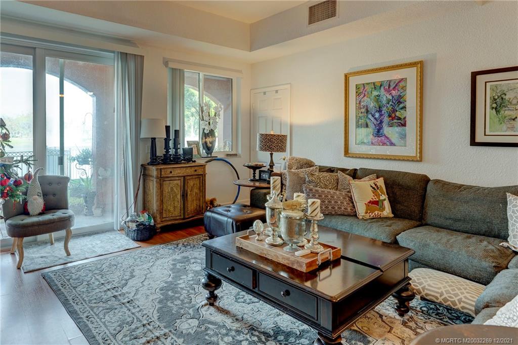 55 Southeast Palermo, Unit 102 Stuart, FL 34994 - Photo 20 of 40 a living room with furniture a rug and a large window