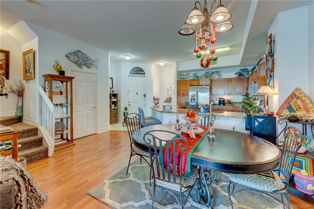 55 Southeast Palermo, Unit 102 Stuart, FL 34994 - Photo 22 of 40 a view of a dining room with furniture and a chandelier