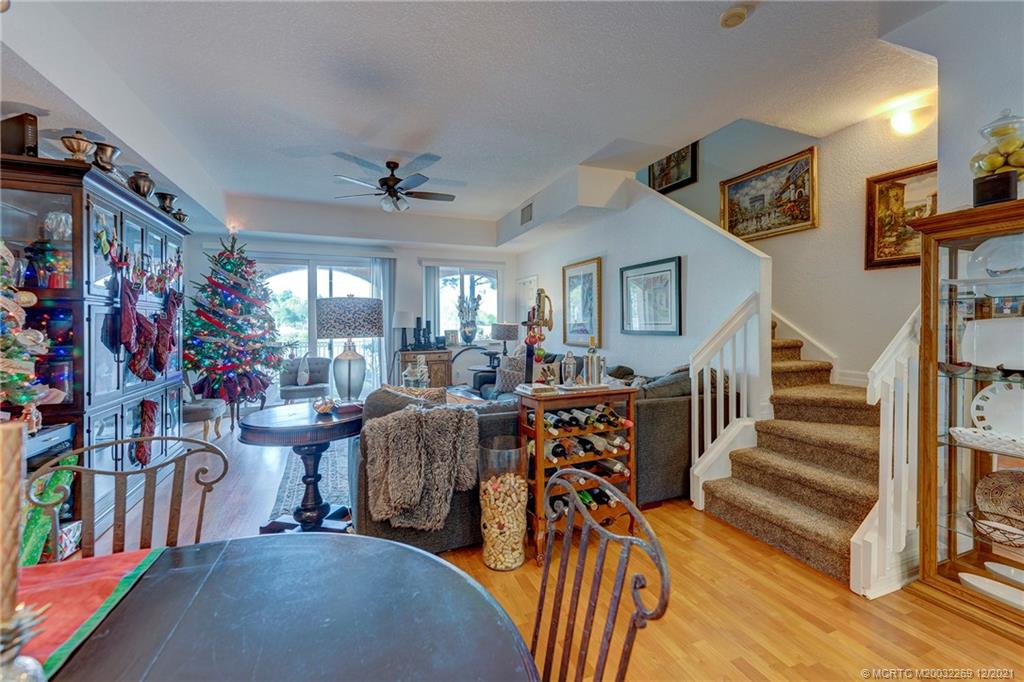 55 Southeast Palermo, Unit 102 Stuart, FL 34994 - Photo 28 of 40 a view of a dining room with furniture a chandelier and wooden floor