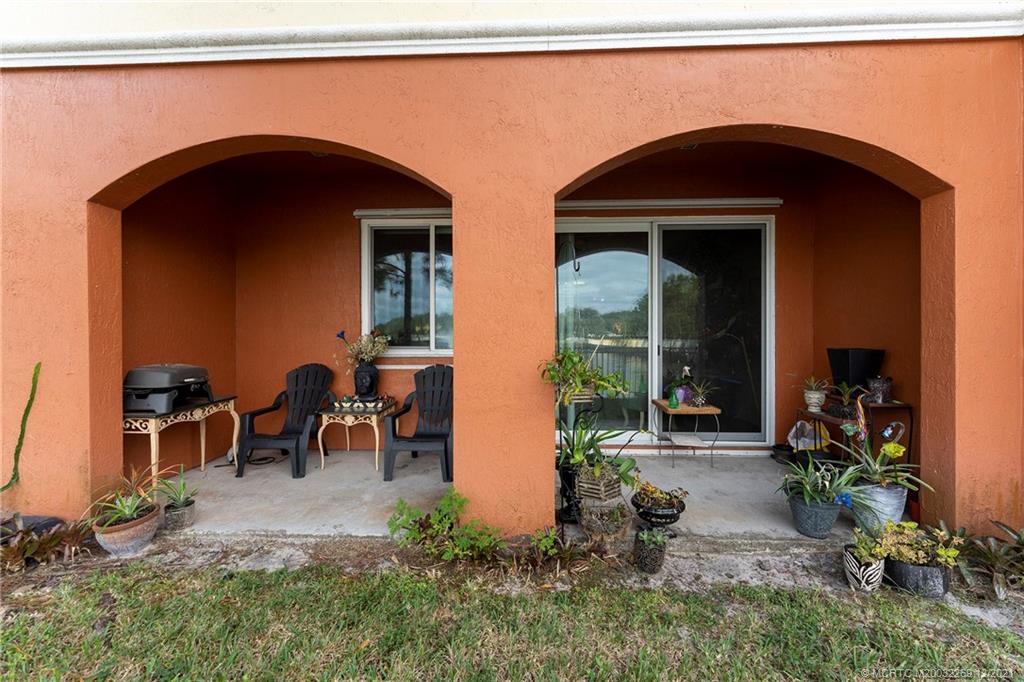 55 Southeast Palermo, Unit 102 Stuart, FL 34994 - Photo 31 of 40 a couple of potted plants in front of a door