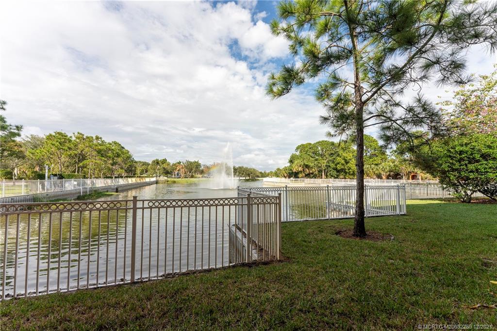 55 Southeast Palermo, Unit 102 Stuart, FL 34994 - Photo 33 of 40 a view of a pathway with a wrought fence