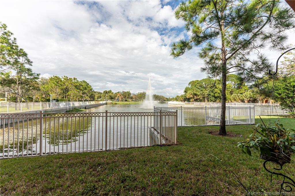 55 Southeast Palermo, Unit 102 Stuart, FL 34994 - Photo 6 of 40 a view of a lake with a garden