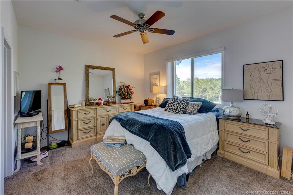 55 Southeast Palermo, Unit 102 Stuart, FL 34994 - Photo 8 of 40 a spacious bedroom with a bed and furniture
