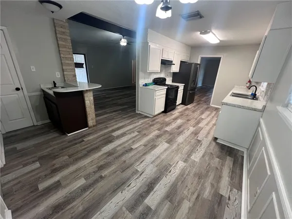 a view of a room with wooden floor and window