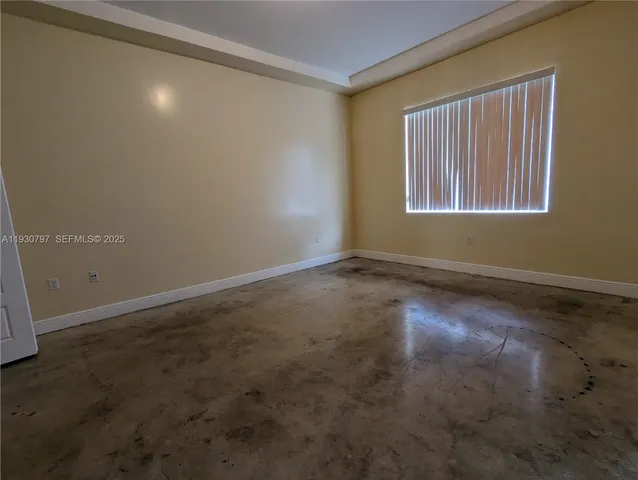 an empty room with a empty space and windows