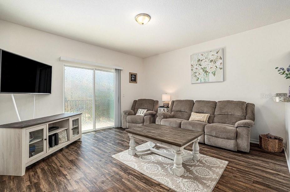 5521 Yellowfin Court New Port Richey, FL 34652 - Photo 3 of 23 a living room with furniture and a flat screen tv