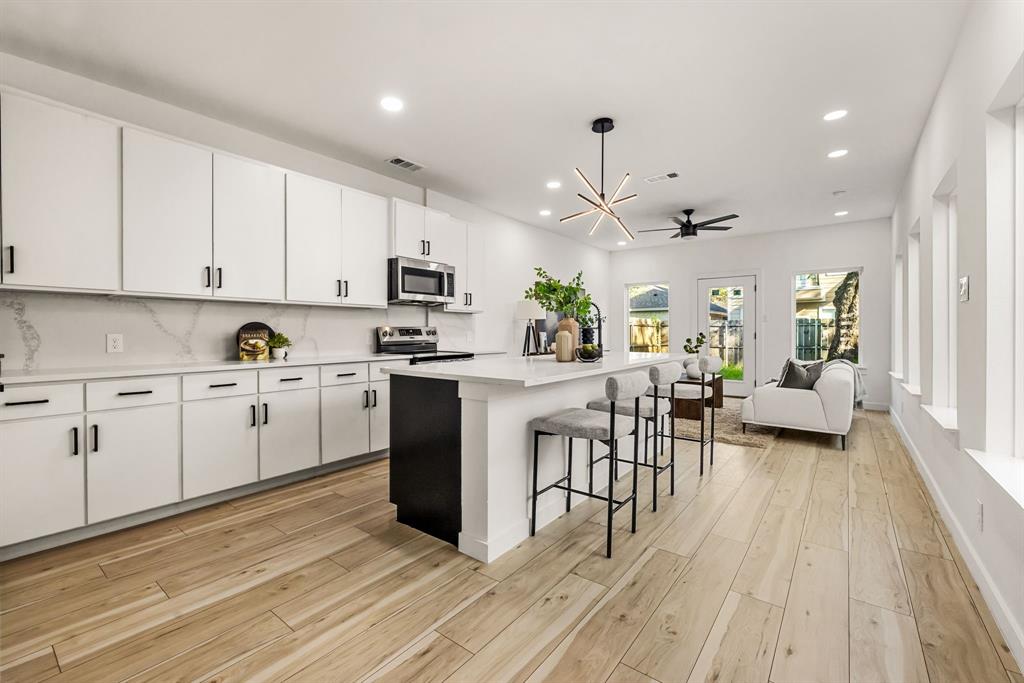 2232 Hooper Street Dallas, TX 75215 - Photo 5 of 23 a kitchen with white cabinets and white appliances