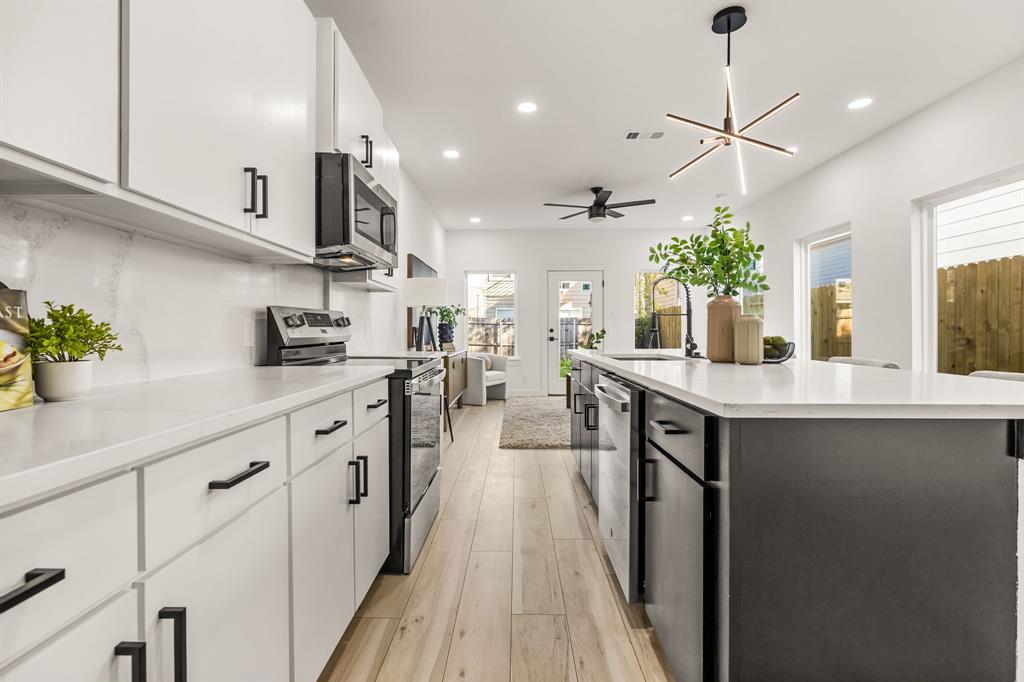 2232 Hooper Street Dallas, TX 75215 - Photo 8 of 23 a kitchen with stainless steel appliances a sink stove and cabinets