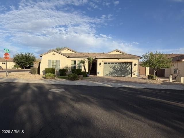 16121 West Berkeley Road Goodyear, AZ 85395 - Photo 1 of 20 a front view of a house with a garden