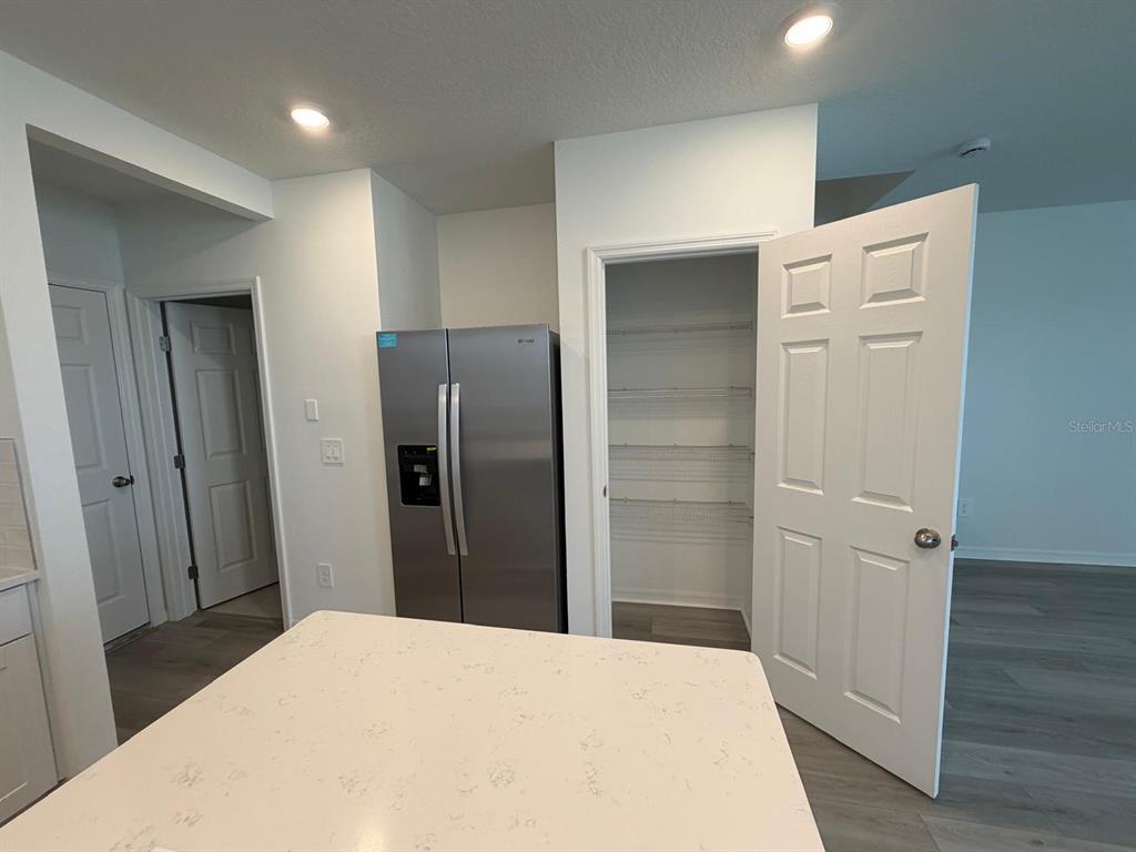 4264 Ranch House Road St. Cloud, FL 34772 - Photo 7 of 34 a bathroom with a refrigerator and a sink