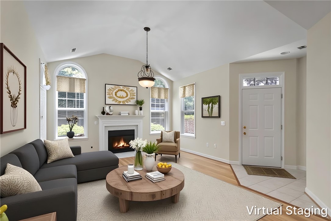 155 Life Style Lane Anderson, SC 29621 - Photo 2 of 49 A welcoming living area boasts high ceilings, a cozy fireplace, and abundant natural light.