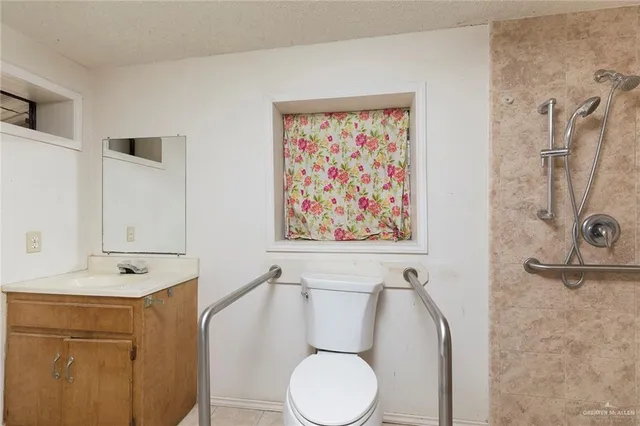 a bathroom with a sink mirror vanity and toilet