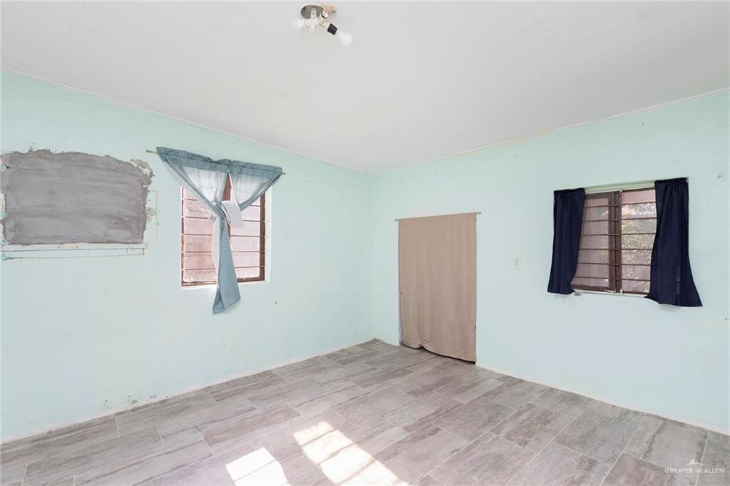 5068 East US Highway 83 Rio Grande City, TX 78582 - Photo 12 of 19 a view of a bedroom with wooden floor and window