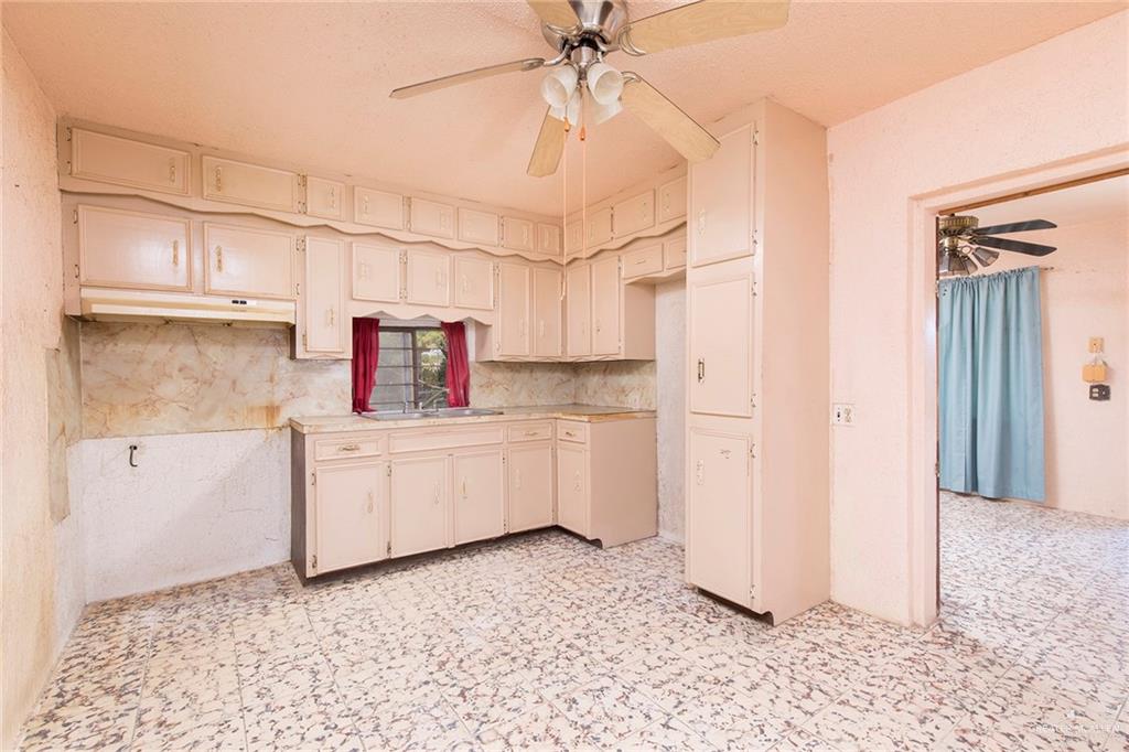 5068 East US Highway 83 Rio Grande City, TX 78582 - Photo 8 of 19 a kitchen with cabinets and window