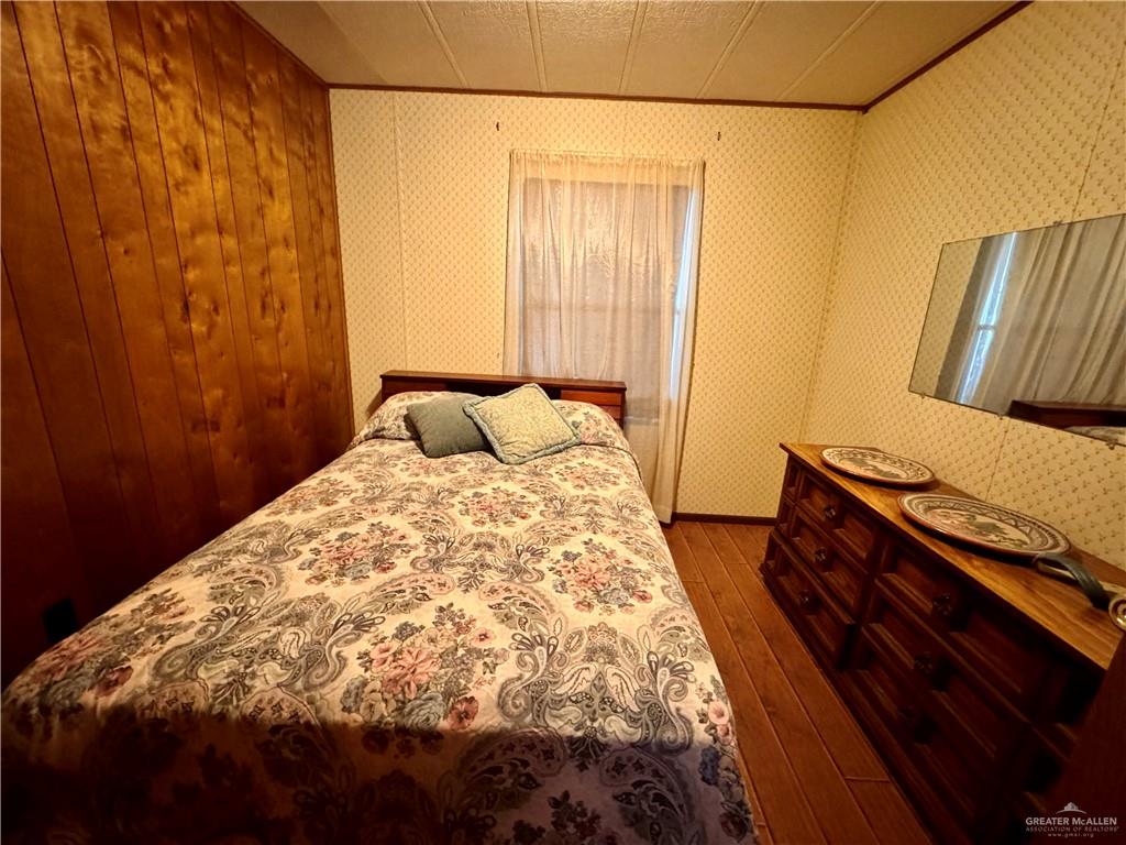 2112 Kelly Mission, TX 78572 - Photo 16 of 24 a bedroom with a bed and wooden floor