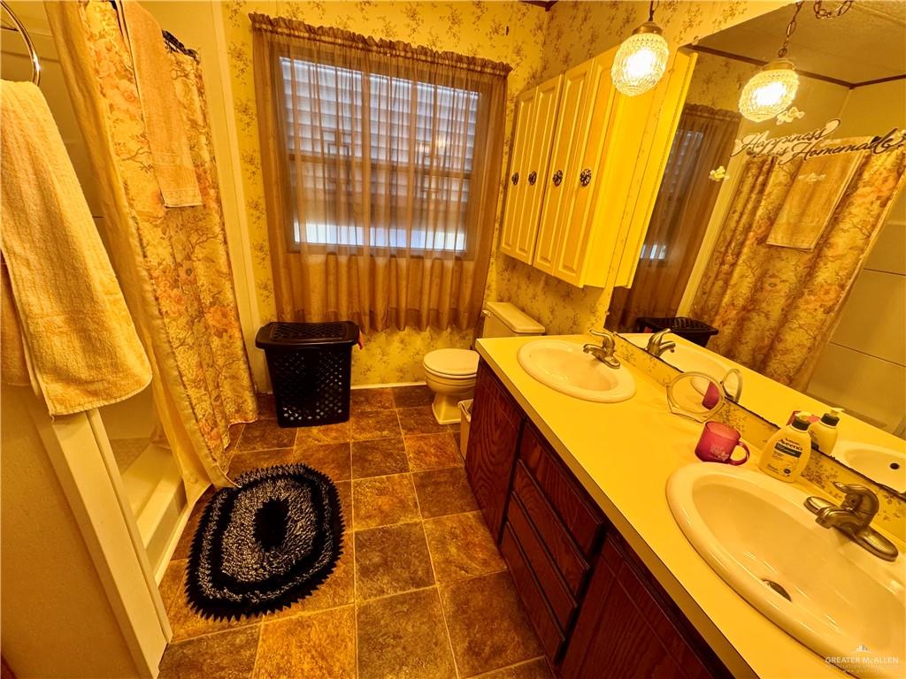 2112 Kelly Mission, TX 78572 - Photo 19 of 24 a bathroom with a sink and a washing machine