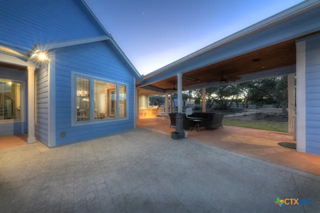 a room with furniture a rug potted plant and a window
