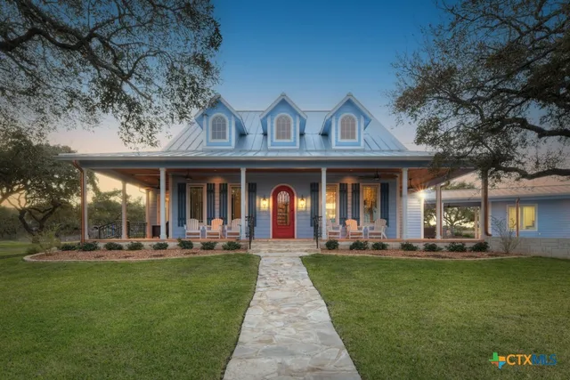 a front view of a house with a garden and patio