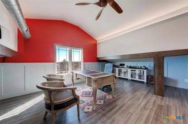 a view of a patio with table and chairs and floor to ceiling window
