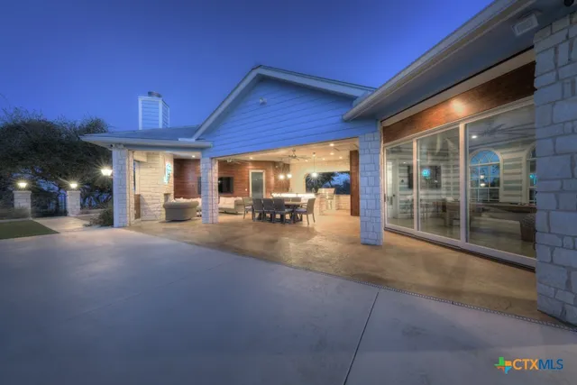 a kitchen with stainless steel appliances kitchen island granite countertop a stove a sink and a dining table with garden view