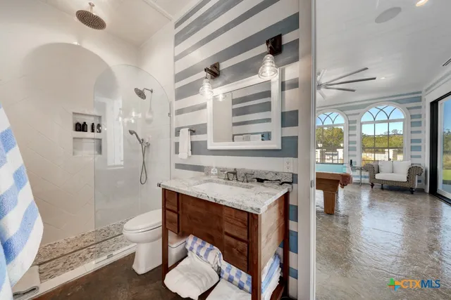 a living room with furniture pool table and flat screen tv