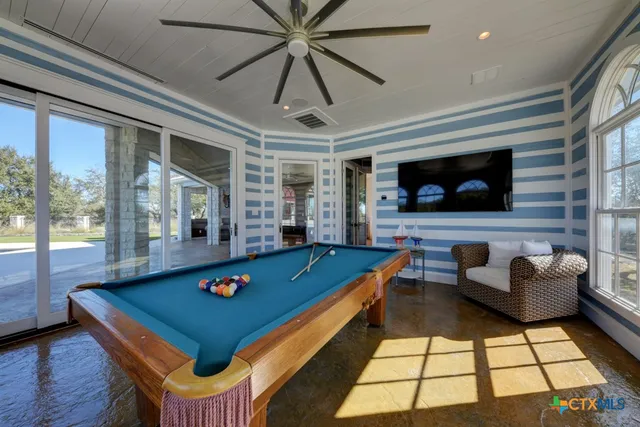 a view of a swimming pool and lounge chairs