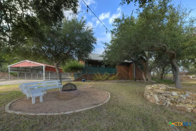 a view of a work space with furniture wooden floor and a ceiling fan