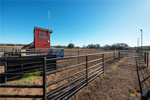 a view of a wooden house with table and chairs