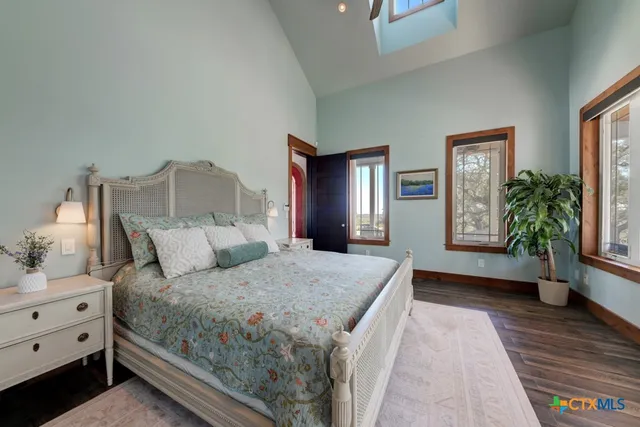 a bedroom with a large bed and a large window