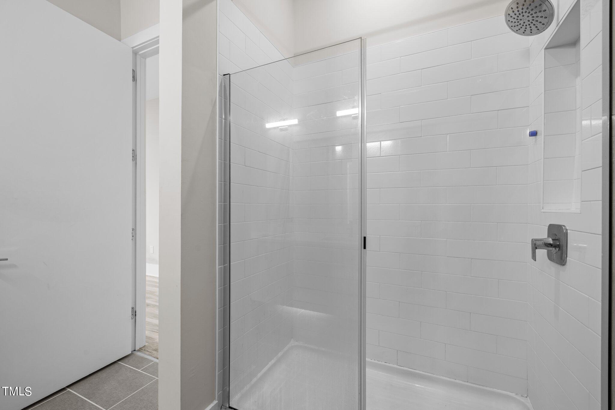 2441 Campus Shore Drive, Unit 312 Raleigh, NC 27606 - Photo 40 of 43 a bathroom with a glass shower door