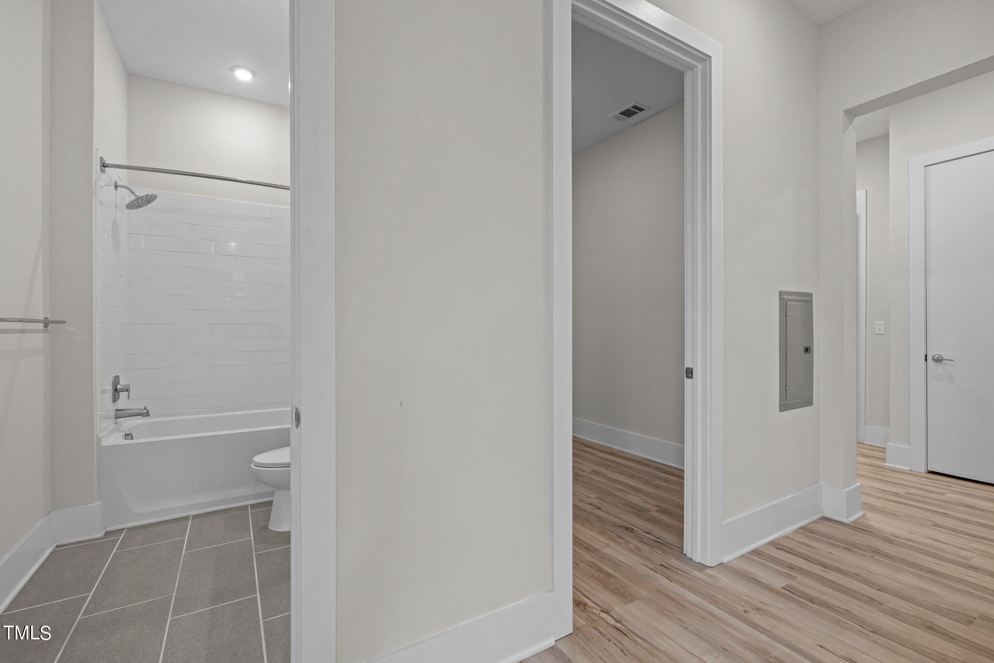 2441 Campus Shore Drive, Unit 312 Raleigh, NC 27606 - Photo 42 of 43 a bathroom with a shower and a glass door