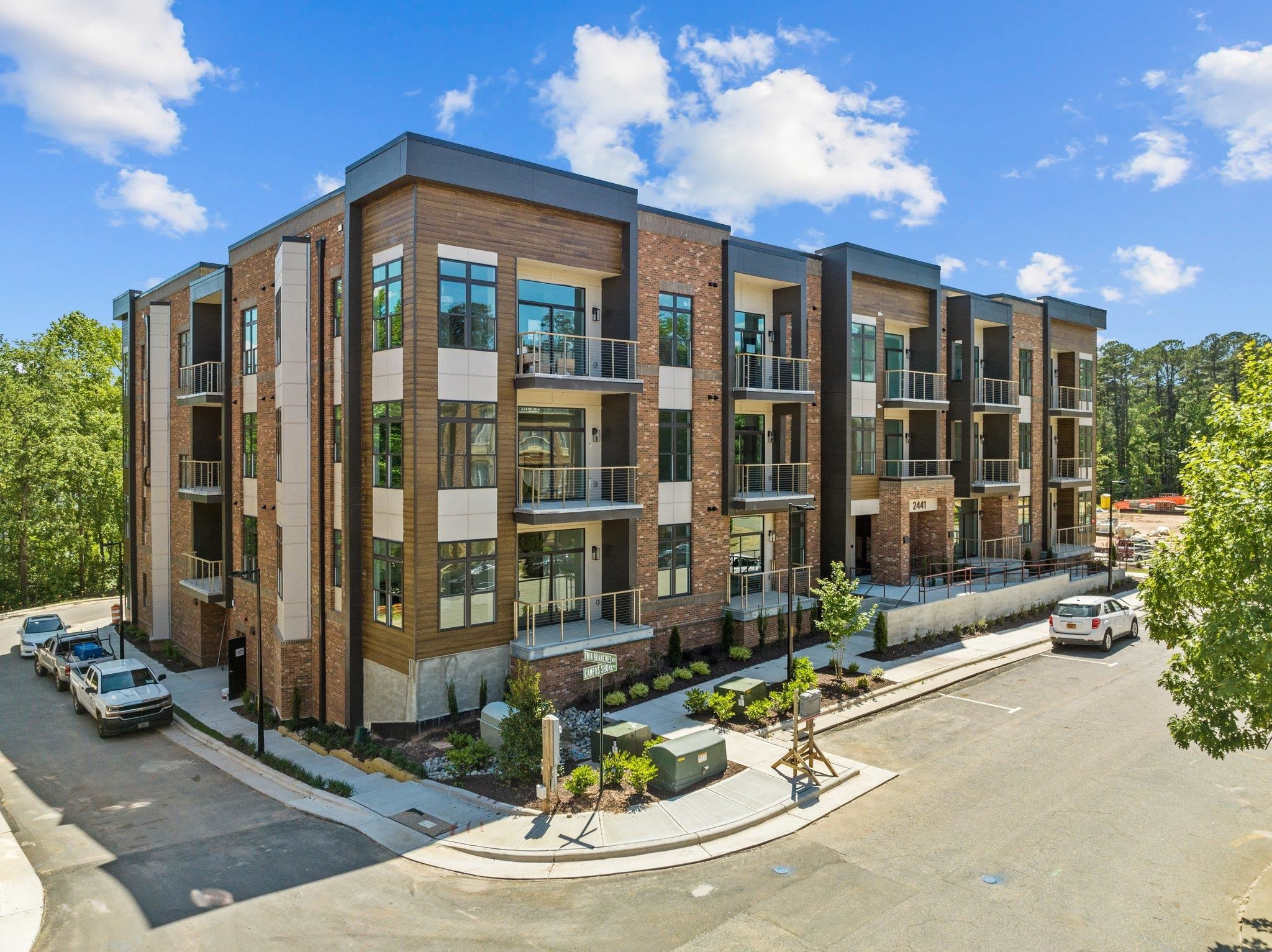 2441 Campus Shore Drive, Unit 312 Raleigh, NC 27606 - Photo 8 of 43 a view of a building with floor to ceiling windows and yard
