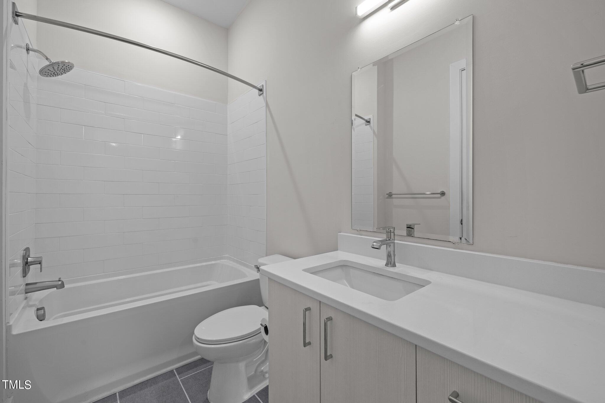 2441 Campus Shore Drive, Unit 312 Raleigh, NC 27606 - Photo 9 of 43 a bathroom with a sink toilet and shower