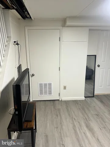 a front view of multi story residential apartment building with retail shops