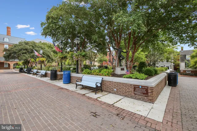 a picture of a bench in front of a wall