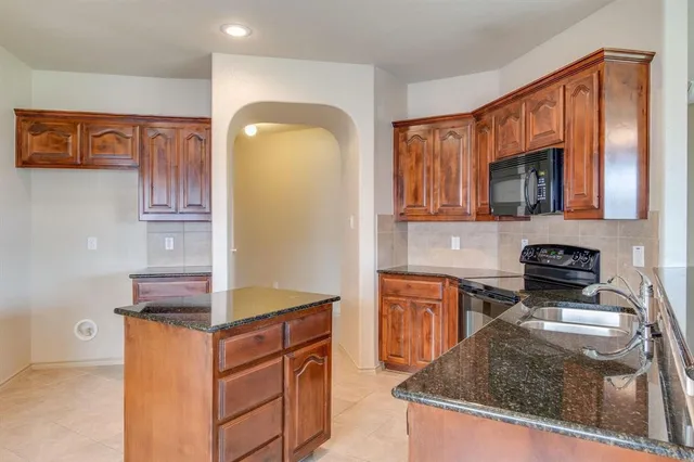 a kitchen with a refrigerator stove and sink