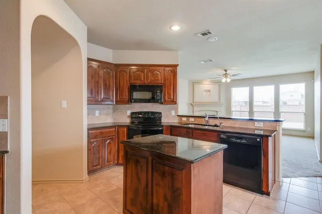 a kitchen with stainless steel appliances a sink stove and cabinets