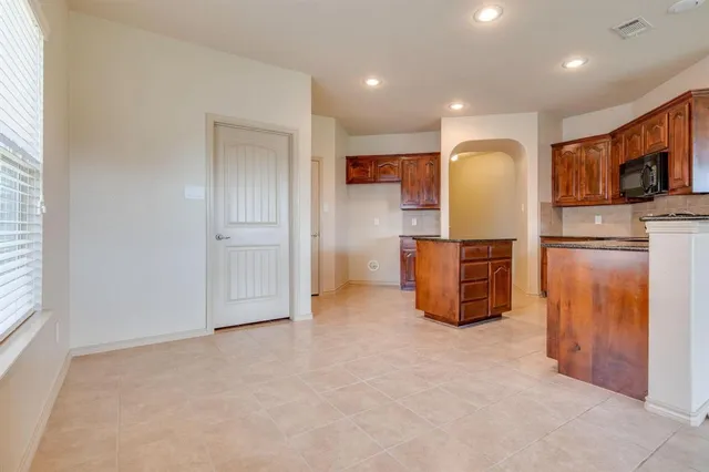 a kitchen with stainless steel appliances a refrigerator and microwave